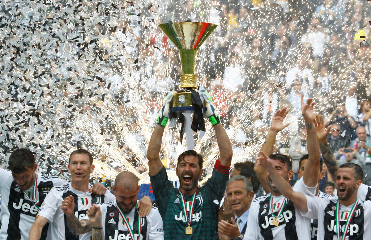 Gianliugi Buffon with the trophy after Juventus title victory.