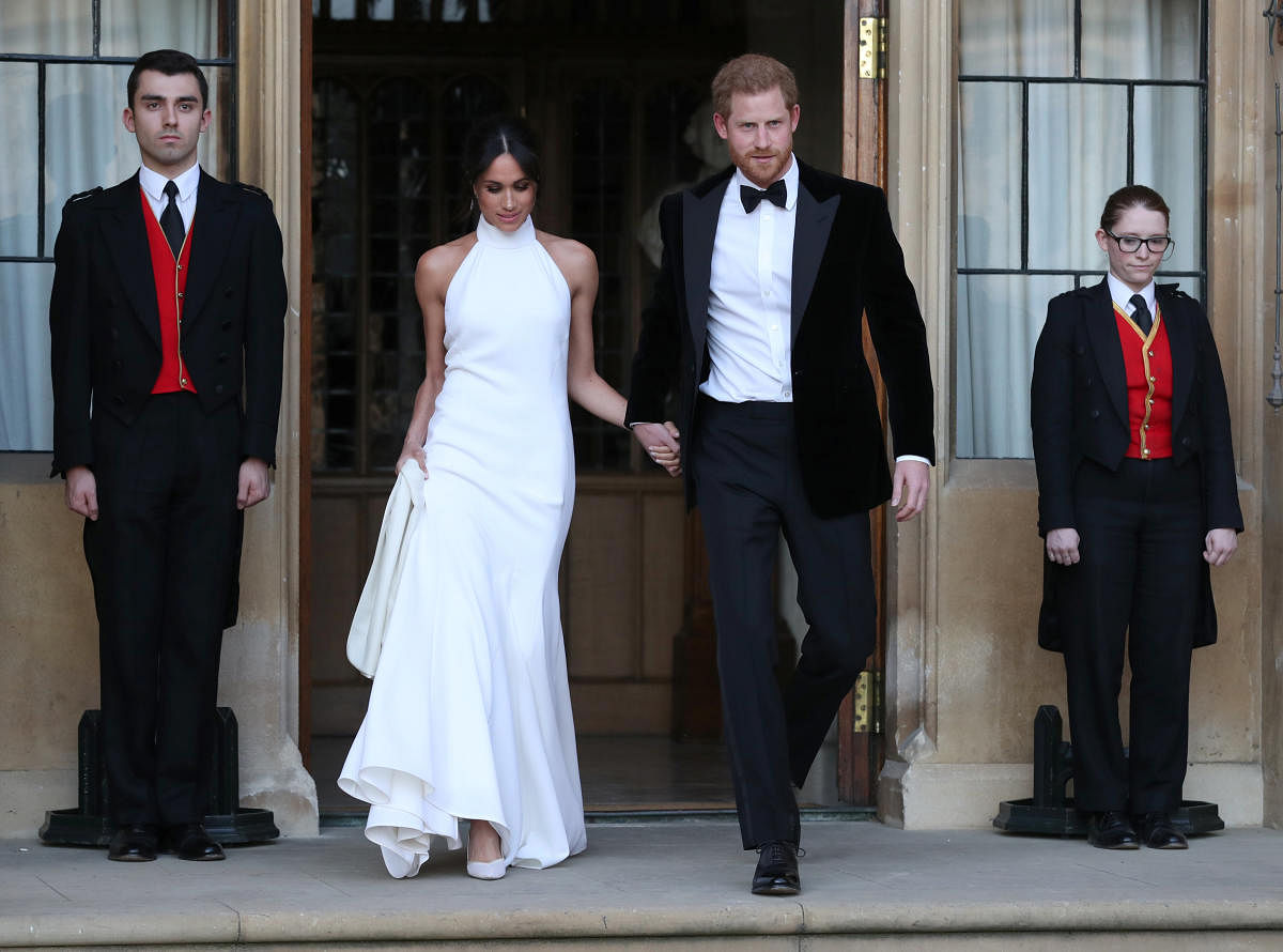 The newly married Duke and Duchess of Sussex, Meghan Markle and Prince Harry, leaving Windsor Castle after their wedding to attend an evening reception at Frogmore House, hosted by the Prince of Windsor, Britain, May 19, 2018