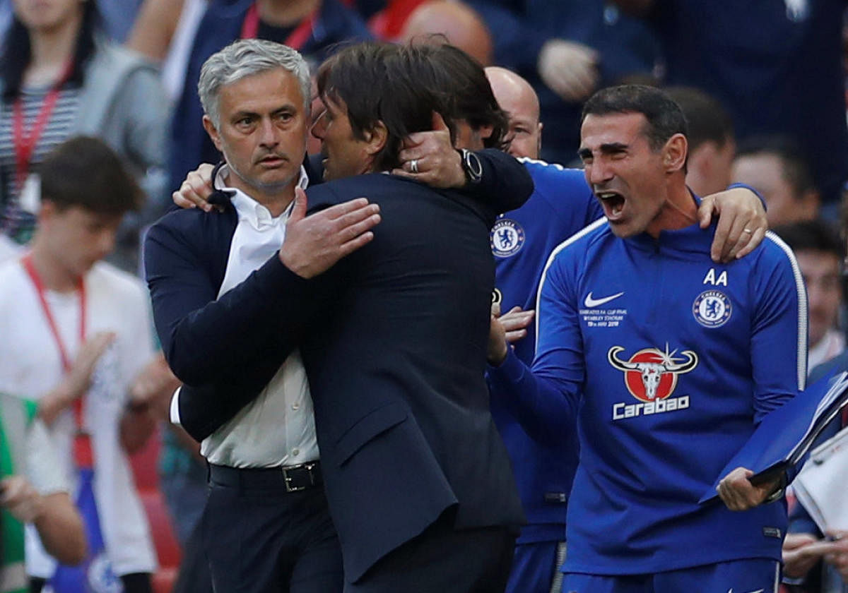 FRIENDS OR FOES?: Manchester United manager Jose Mourinho congratulates Chelsea manager Antonio Conte. Reuters