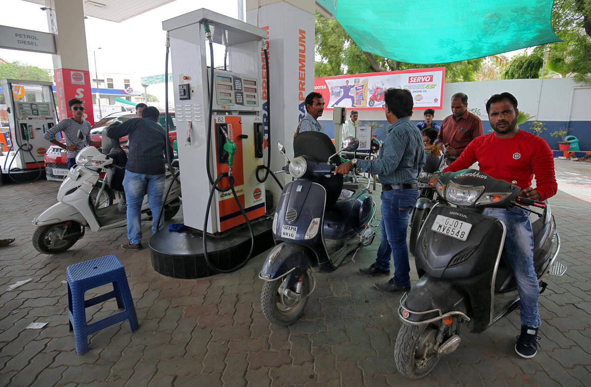 People get their two-wheelers filled with petrol at a fuel station in Ahmedabad (Reuters file photo)