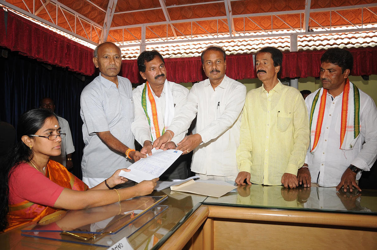 M Lakshmana of the Congress, files nomination papers with Mysuru Regional Commissioner P Hemalatha, also Election Officer, to contest in the biennial elections from the South-West Teachers constituency to the Legislative Council in Mysuru on Monday. MP R