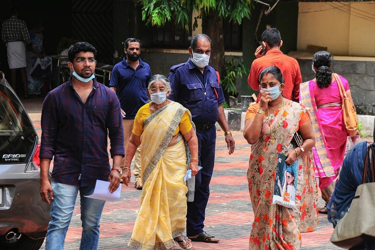 Hospital staff and family members of the patients admitted at the Kozhikode Medical College wear safety masks as a precautionary measure after the 'Nipah' virus outbreak, in Kozhikode, on Monday. PTI Photo