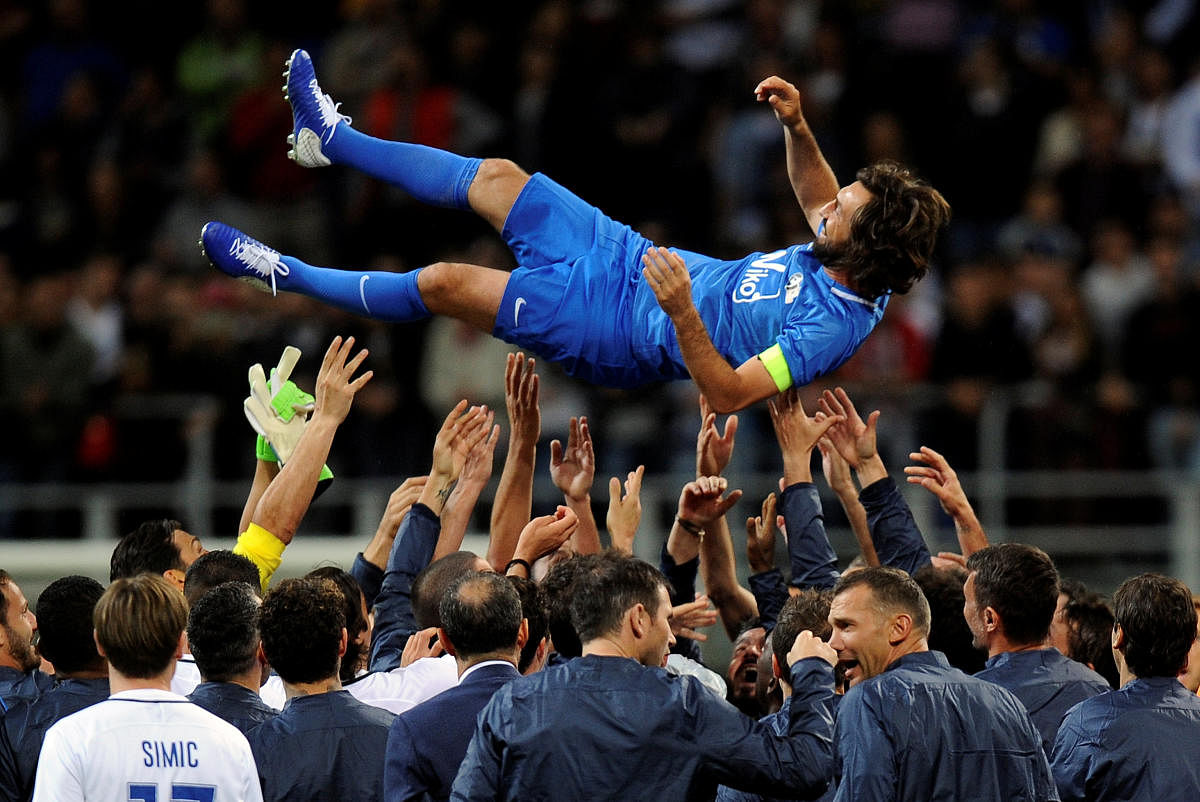 BIDDING GOODBYE Former Italian legend Andrea Pirlo is lifted up at the end his farewell match at the San Siro stadium in Milan on Monday. Reuters