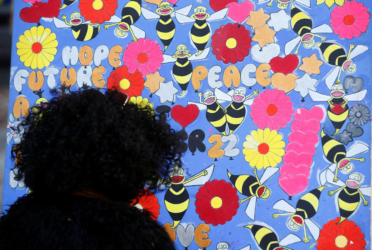 A woman looks at a tribute in St Anne's Square on the first anniversary of the Manchester Arena bombing, in Manchester. Reuters Photo