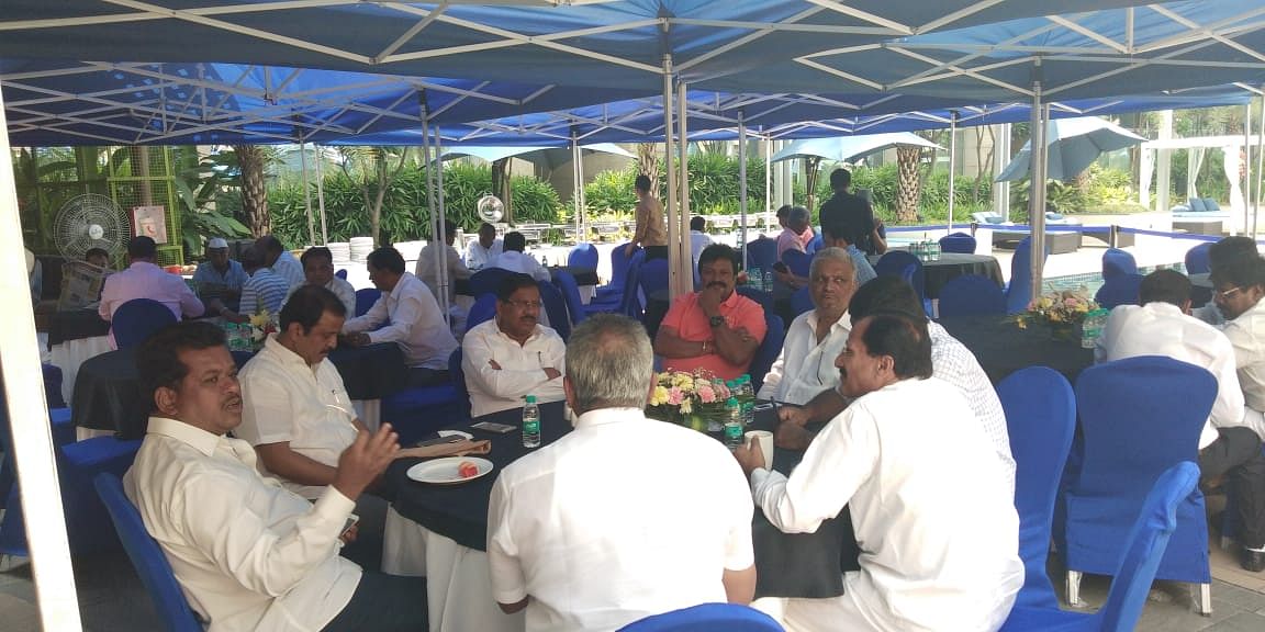 Congress leaders chat over breakfast by the poolside at the Hilton on Tuesday.