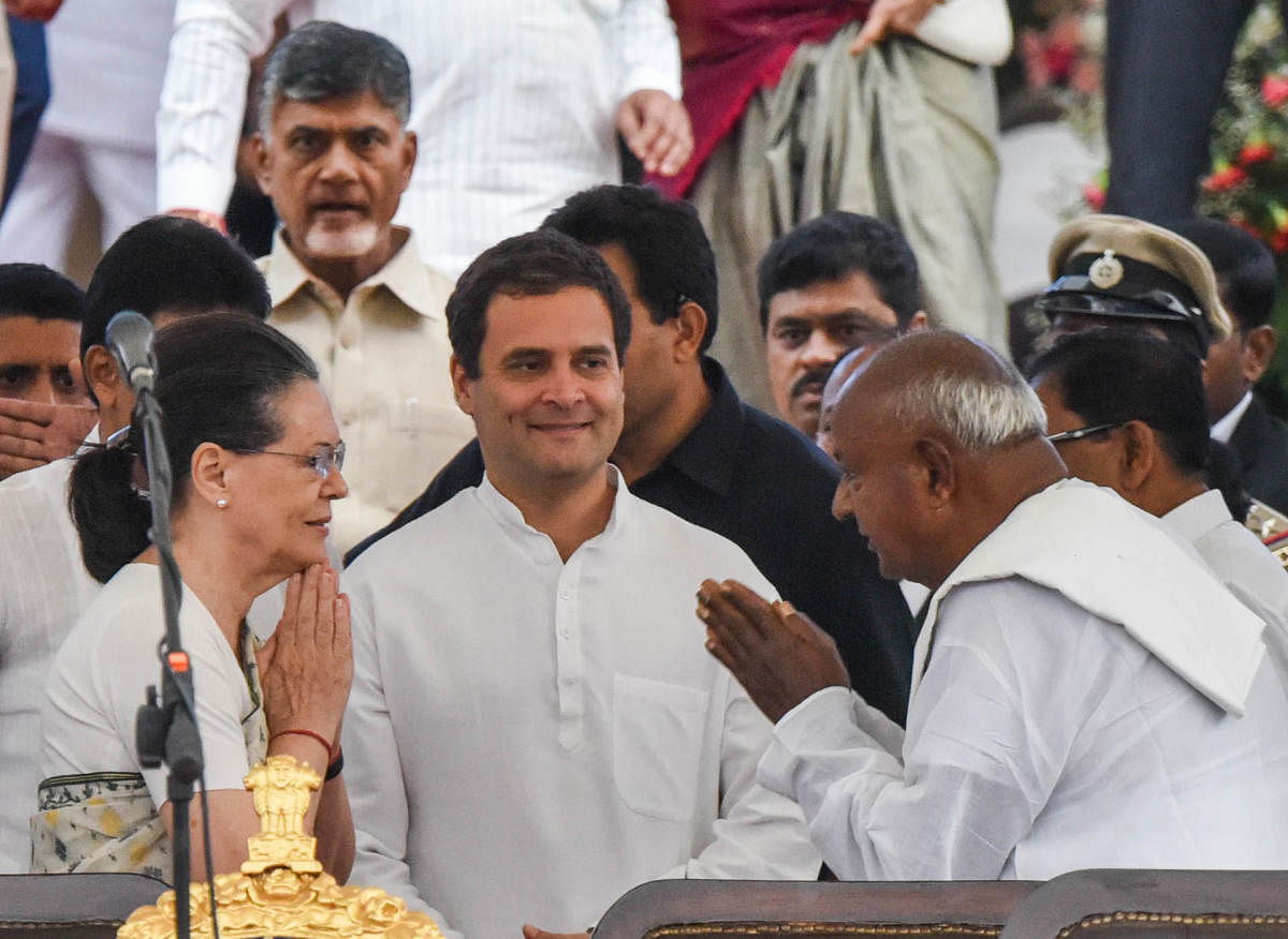 UPA chairperson Sonia Gandhi greets JD(S) supremo H D Deve Gowda during the swearing-in ceremony at Vidhana Soudha, Bengaluru, on Wednesday. AICC president Rahul Gandhi looks on. DH PHOTO