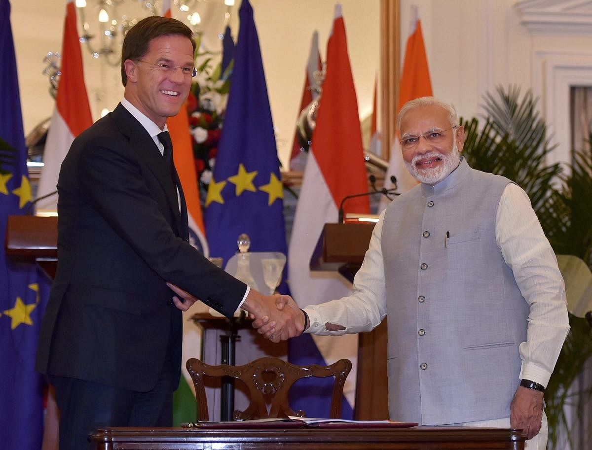 Prime Minister Narendra Modi shakes hands with Netherlands Prime Minister Mark Rutte after signing 'International Solar Alliance' agreement at Hyderabad House, in New Delhi, on Thursday. PTI