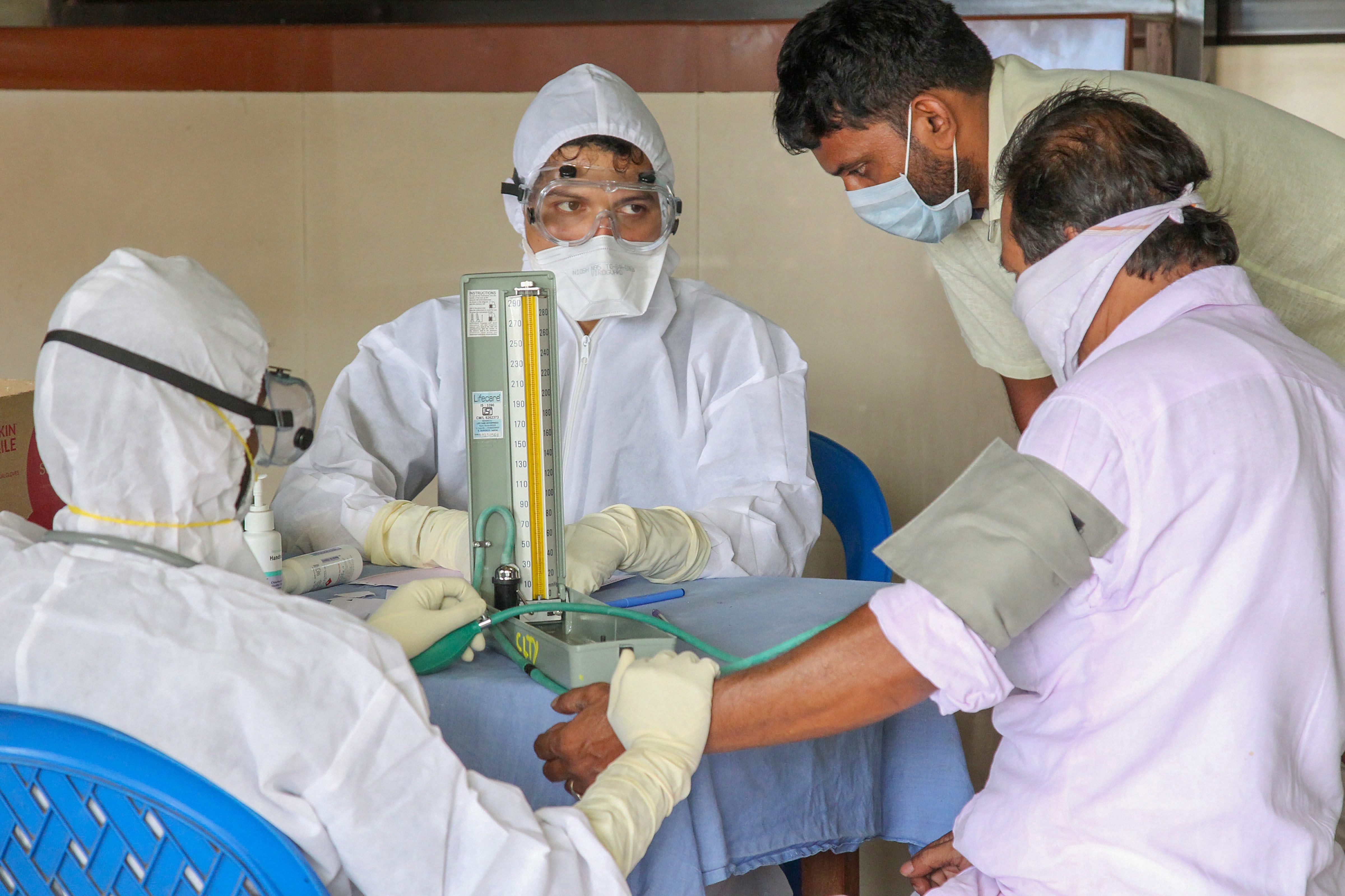 Doctors and patients wear safety masks as a precautionary measure after the Nipah virus outbreak, at a Medical college, in Kozhikode, on Wednesday. PTI