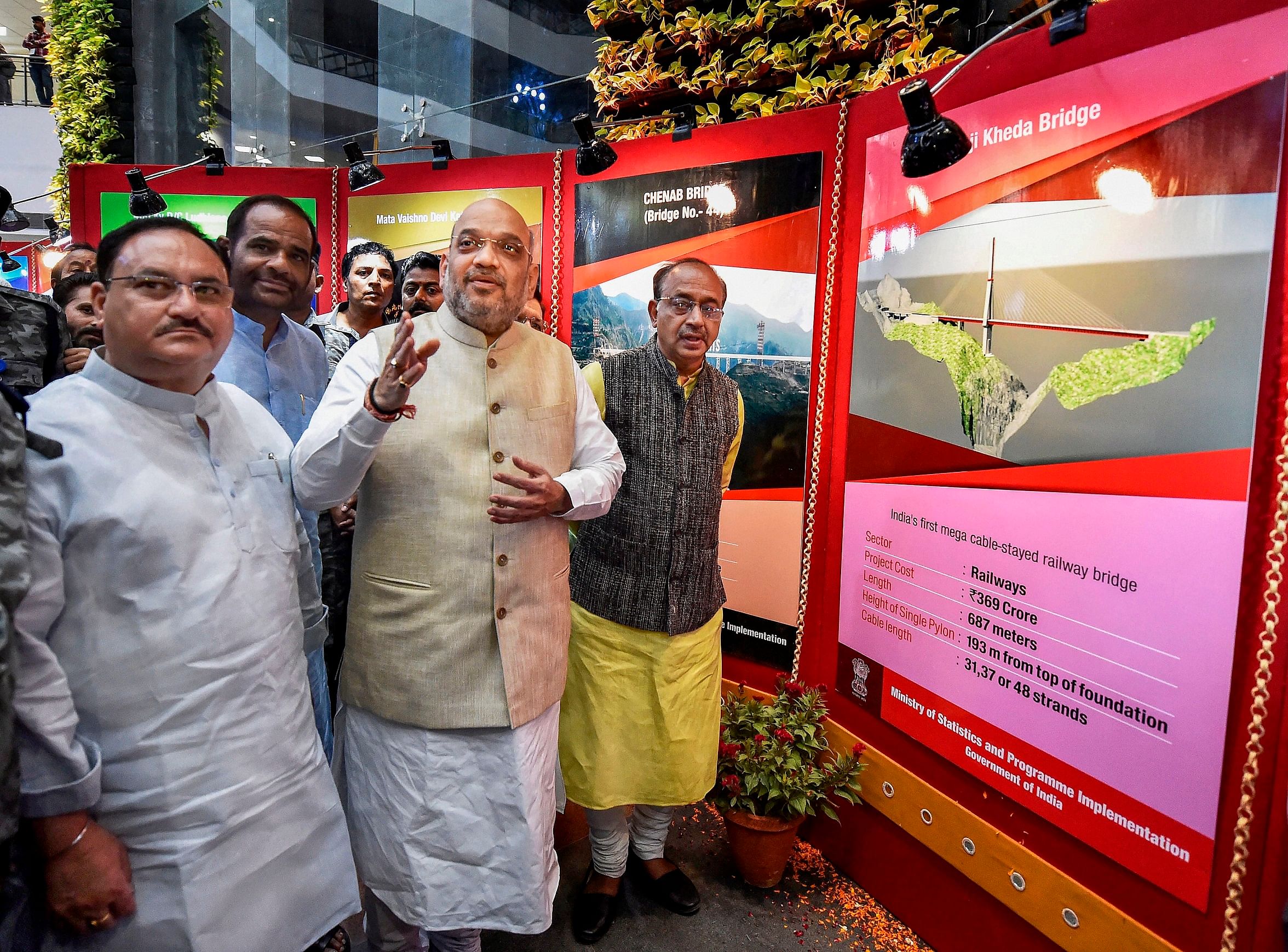 BJP president Amit Shah with Union Minister of Parliamentary Affairs and Statistics Vijay Goel and Union Health Minister J P Nadda inaugurates a photo exhibition on completion of 4 years of the NDA government, at Ambedkar International Centre, in New Delhi, on Friday. PTI 