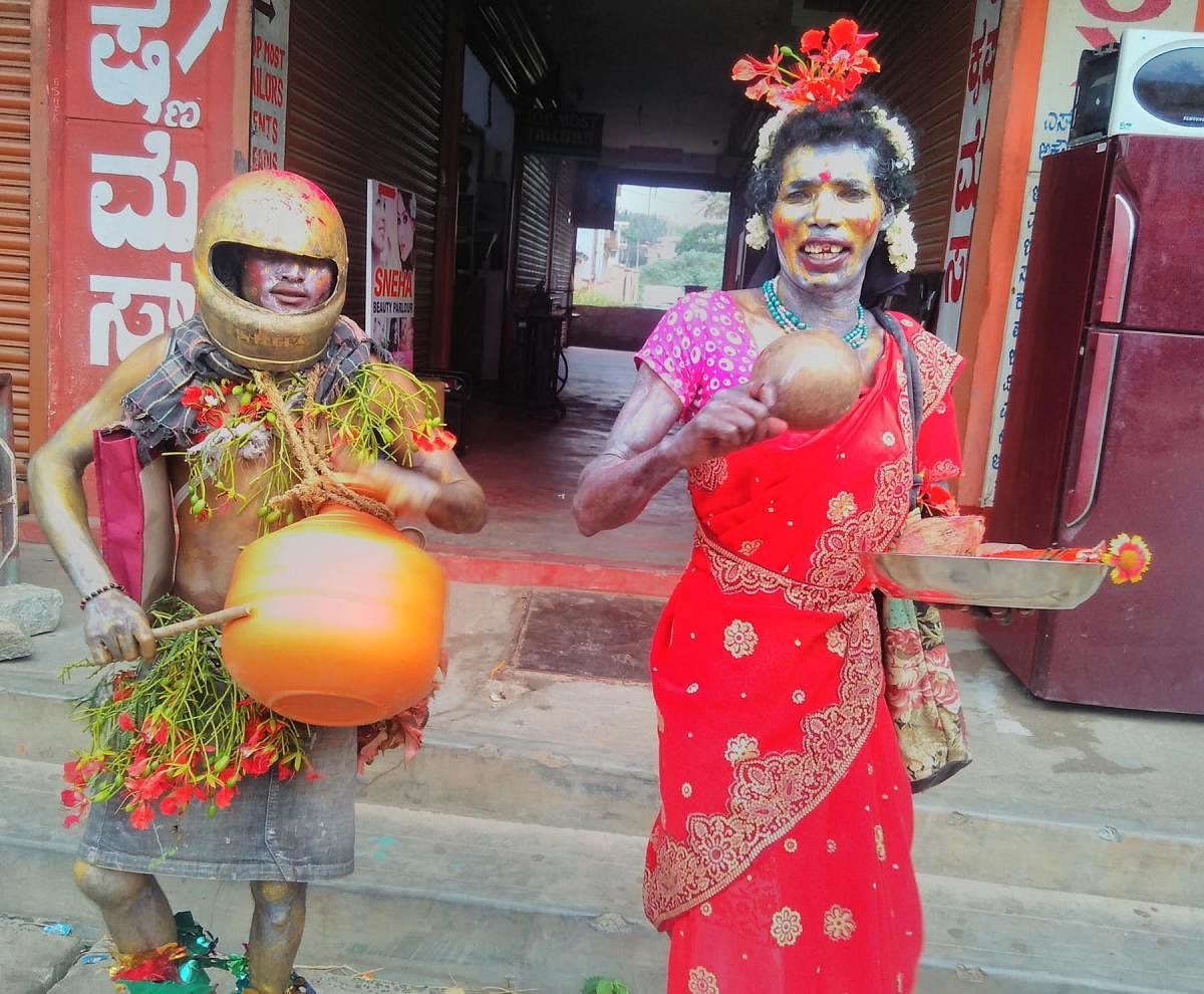 Tribals dress up in weird costumes to celebrate 'kunde habba' on Devarapura temple premises near Titimathi, Gonikoppa, Kodagu district.