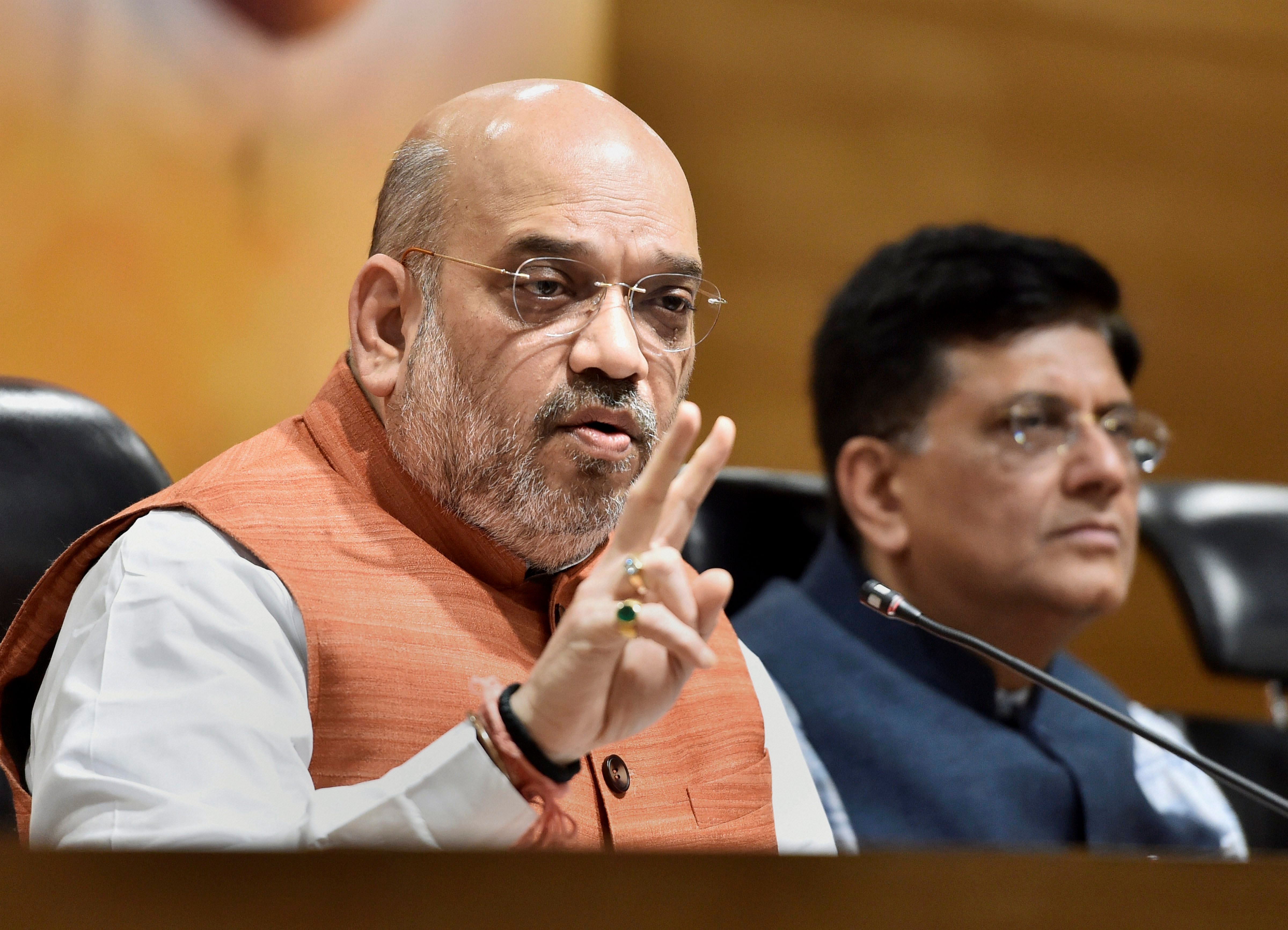 BJP National President Amit Shah addresses a press conference at BJP headquarters, in New Delhi, on Saturday. Union Minister Piyush Goyal also seen in the pix. PTI 