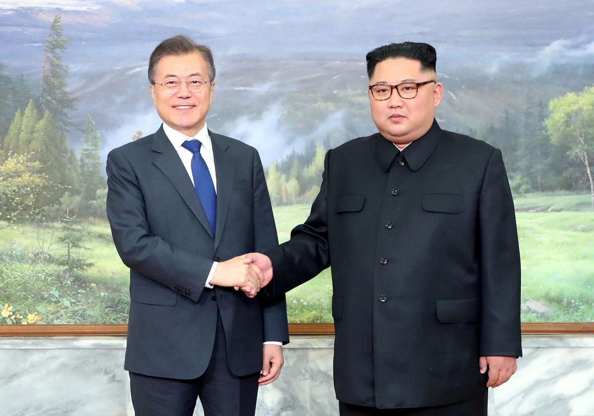 South Korean President Moon Jae-in shakes hands with North Korean leader Kim Jong Un during their summit at the truce village of Panmunjom, North Korea, in this handout picture provided by the Presidential Blue House on May 26, 2018. The Presidential Blue