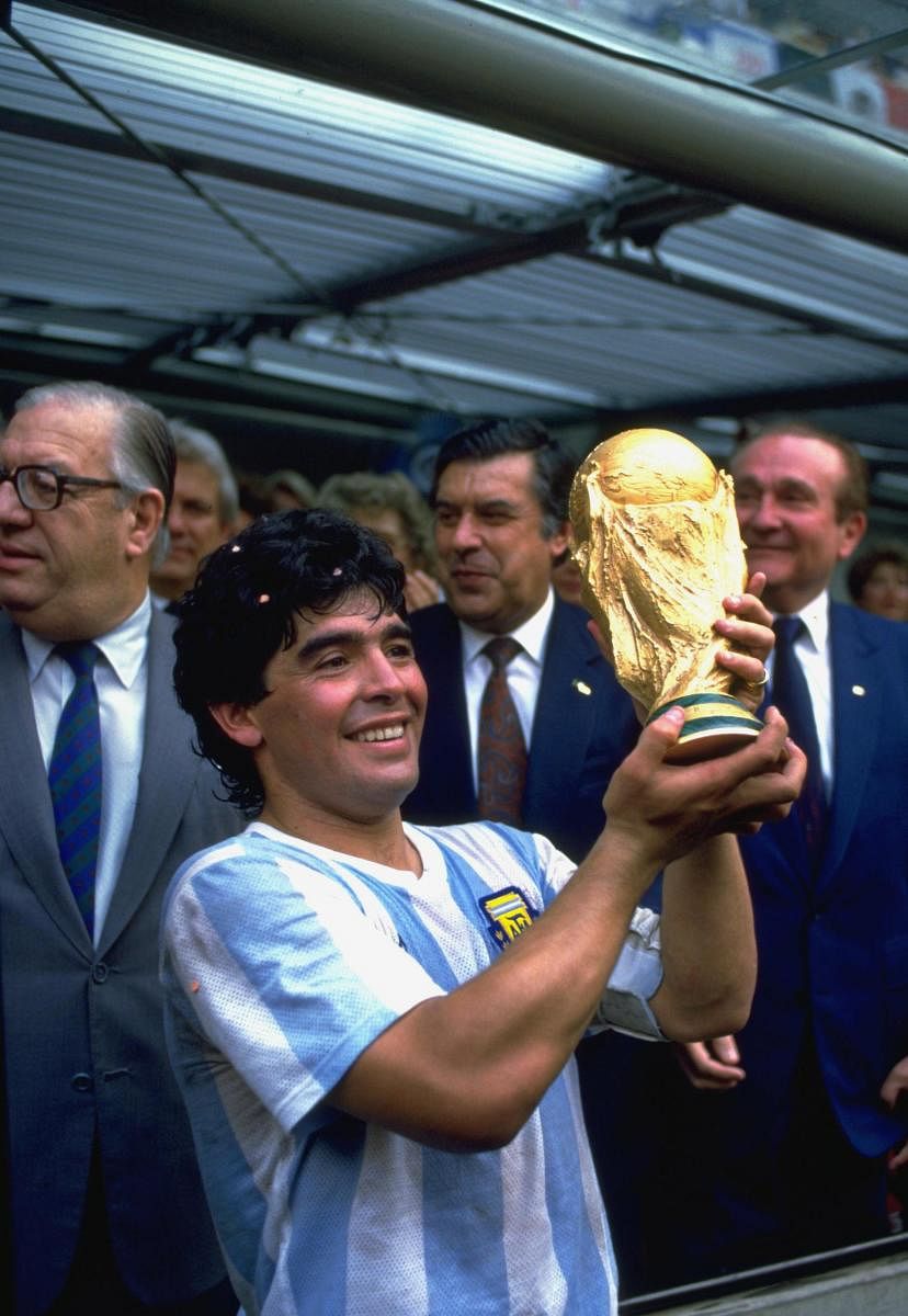 Diego Maradona holds aloft the 1986 FIFA World Cup trophy.