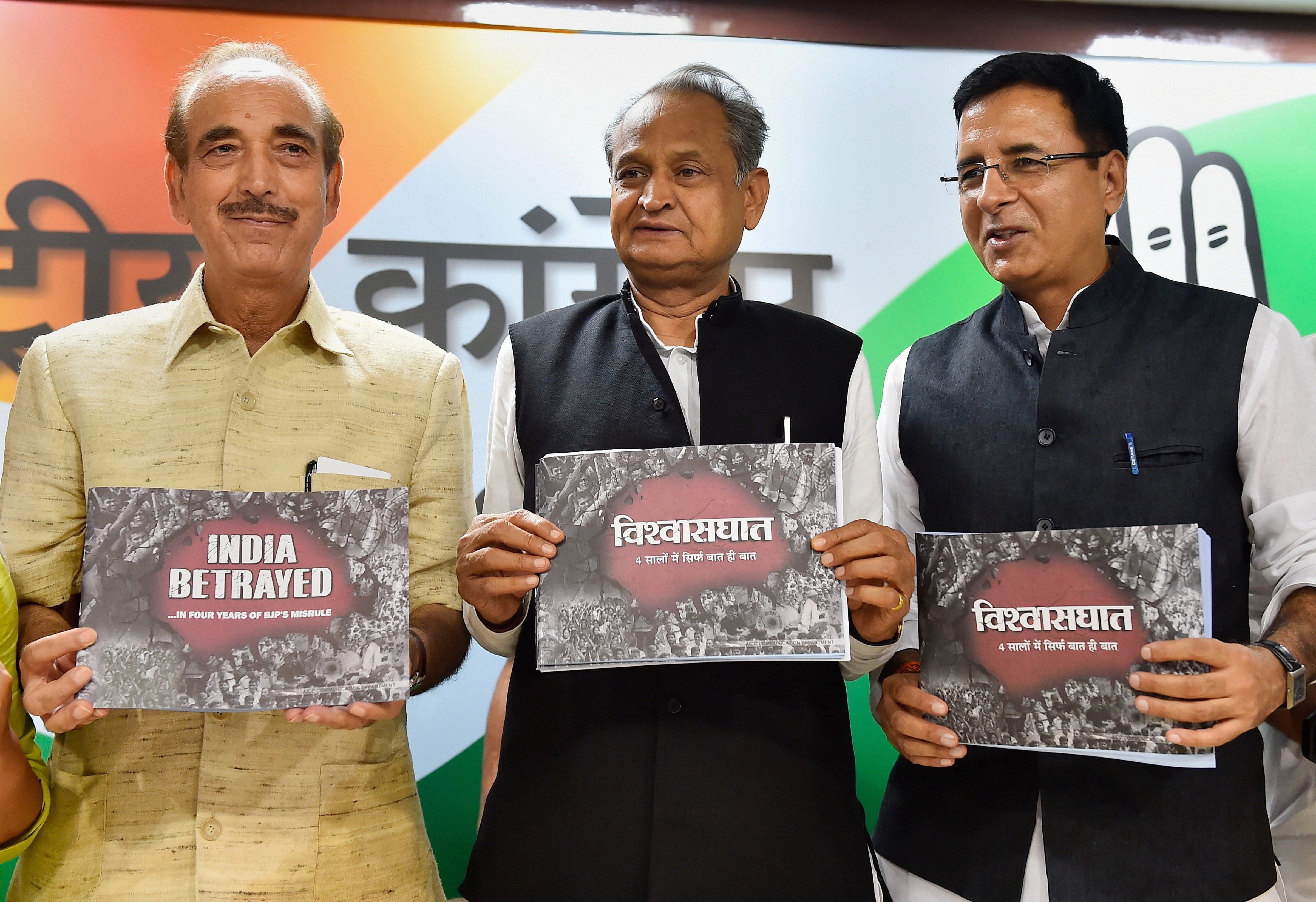 Gehlot, AICC National Spokesperson Randeep Singh Surjewala and All India Mahila Congress President Sushmita Dev release a booklet "India Betrayes ... In Four Years of BJP's Misrule" during a press conference, in New Delhi on Saturday. PTI 
