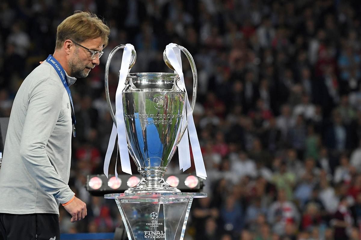Liverpool's coach Jurgen Klopp walks past the trophy after the Champions League final.