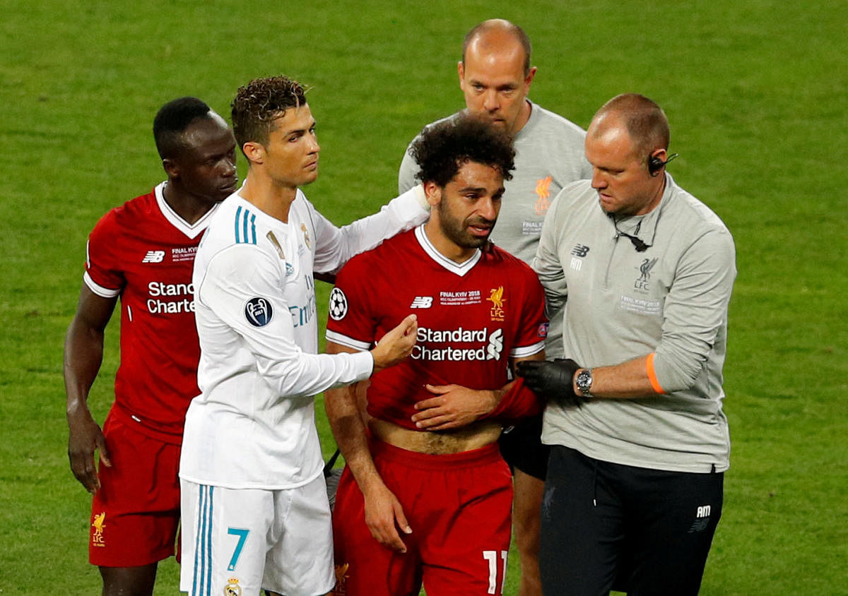 Cristiano Ronaldo consoles Mo Salah as he leaves the field in tears after suffering a shoulder injury. Reuters