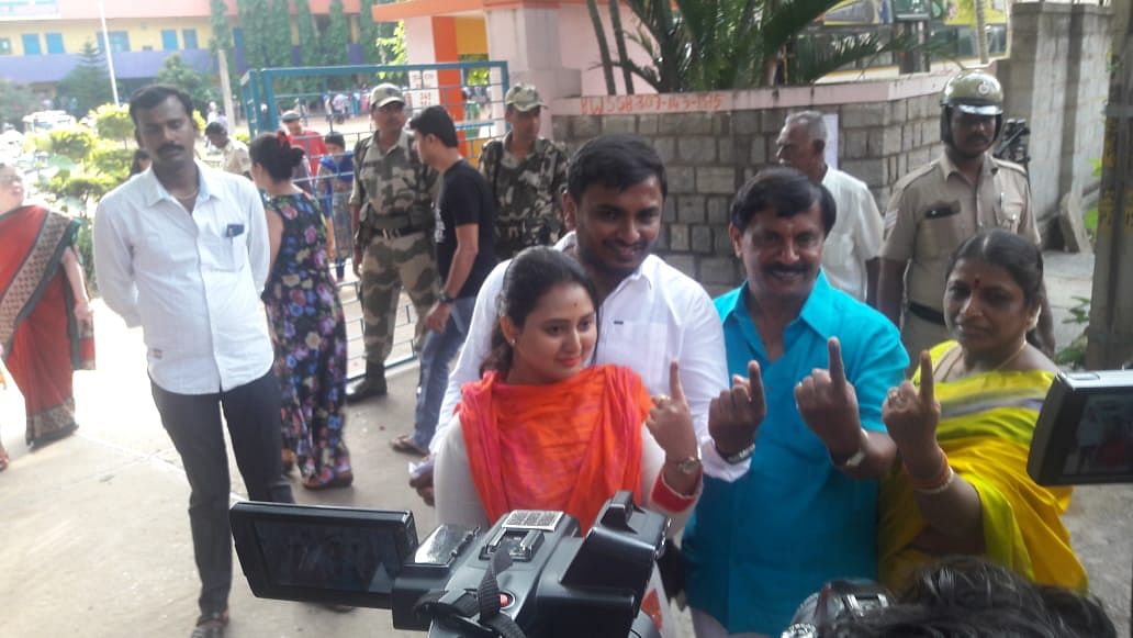 Kannada actor Amulya and her family show their inked fingers after casting their vote in RR Nagar polls, in Bengaluru on Monday. DH Photo