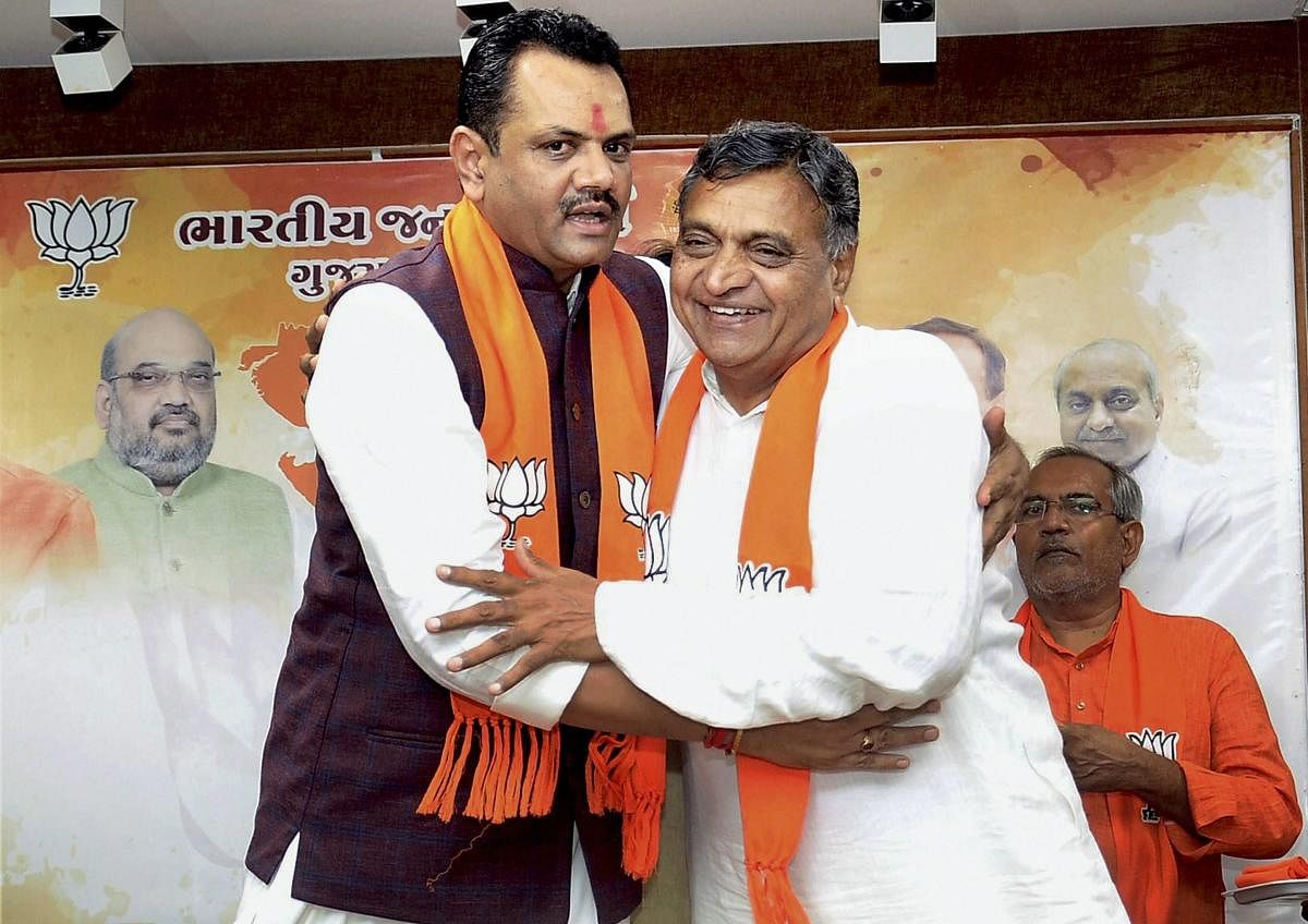 Gujarat BJP President Jitu Vaghani welcomes Congress MLA P I Patel as he joins BJP in Gandhinagar. PTI file photo. 