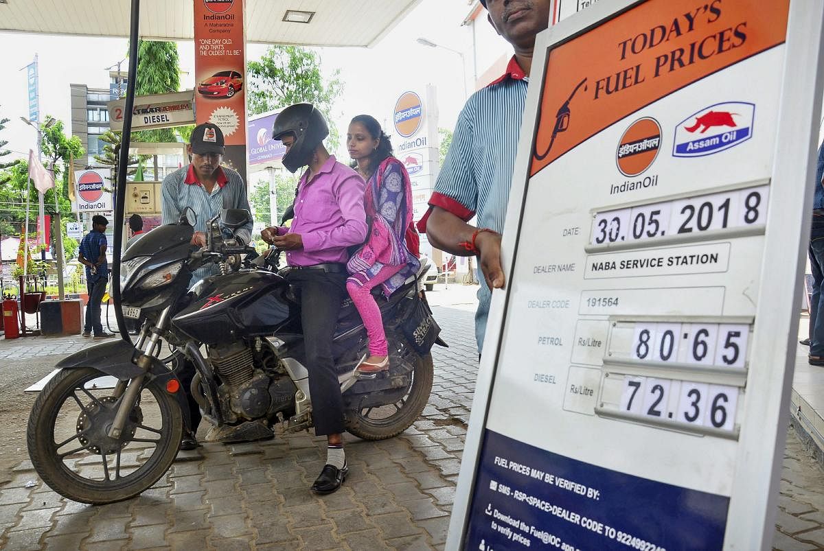 Guwahati: An employee attends a customer at a petrol pump, as the prices of petrol and diesel keep showing volatility, in Guwahati on Wednesday, May 30, 2018. (PTI Photo) (PTI5_30_2018_000031B)