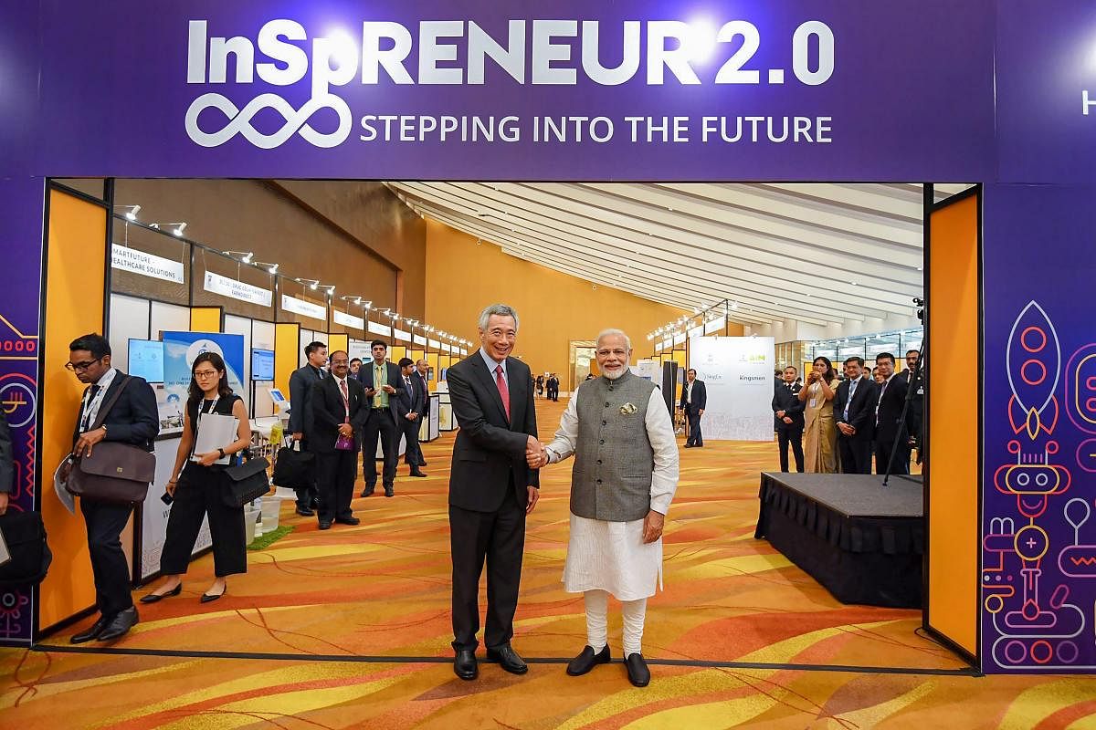 Prime Minister Narendra Modi shakes hands with Singapore Prime Minister Lee Hsien Loong during the India-Singapore Enterprise and Innovation Exhibitions, at Marina Bay Sands Convention Centre, in Singapore on May 31, 2018. (PTI Photo/PIB)