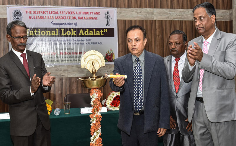 High Court Judge Justice Jayant Patel inaugurates National Lok Adalat, organised by District Legal Servises Authority and Gulbarga BAR Association at District Court in Kalaburgi on Saturday. Seen - Principal Sessions & DIstrict Judge B V Patil and President BAR Association R K Hiremat. DH File photo. 