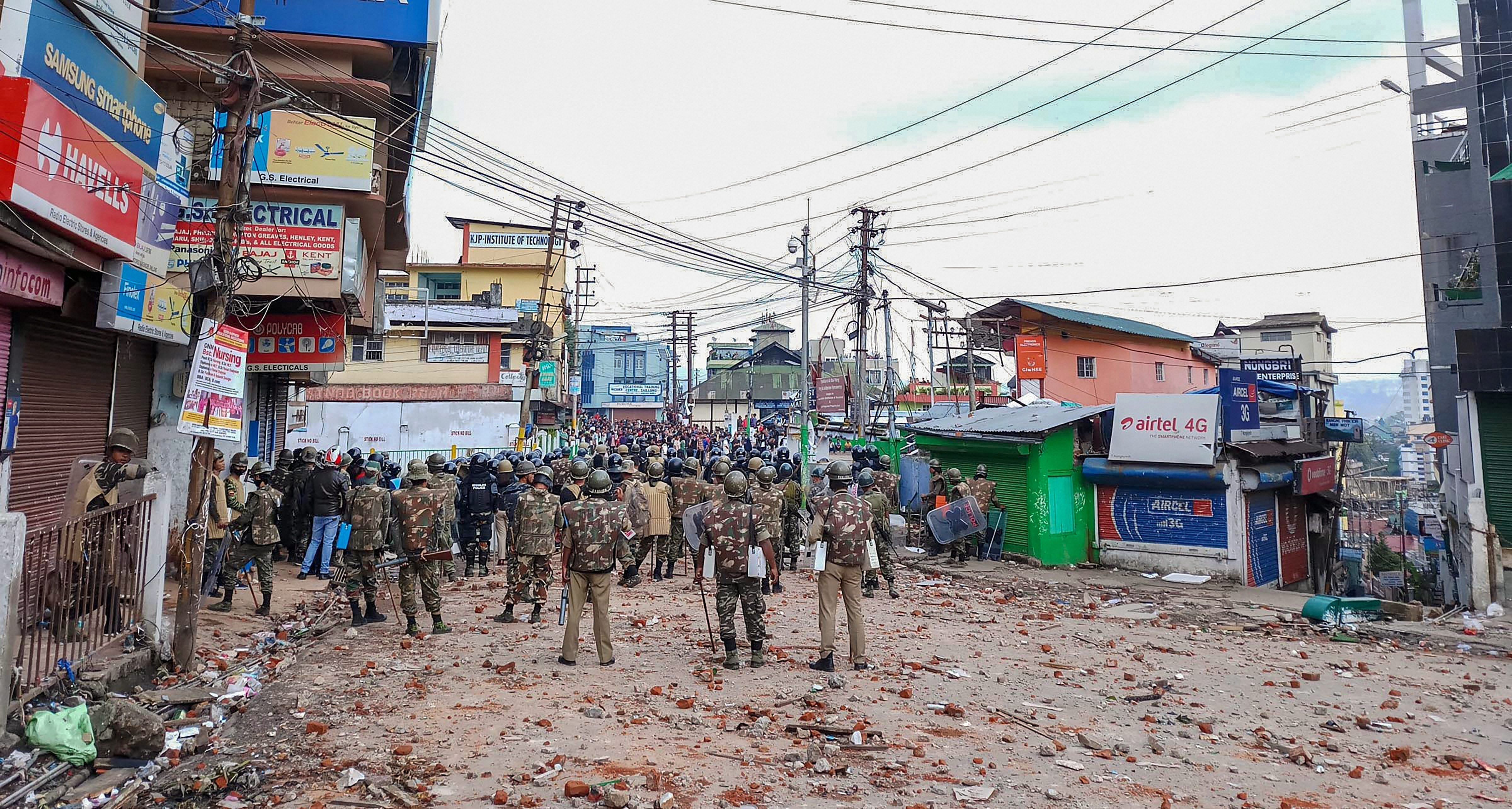 Securitymen stand guard a street during curfew in Shillong on Saturday. PTI