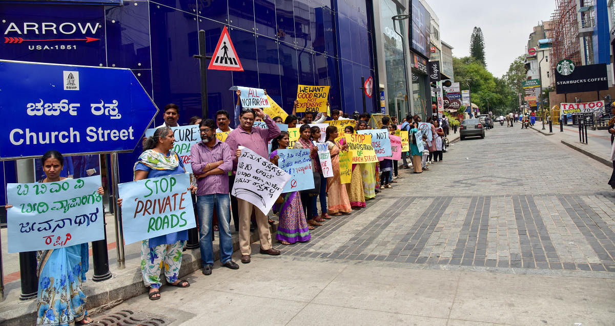 People take part in a silent protest on Friday against outsourcing the maintenance of Church Street. DH PHOTO/B H Shivakumar