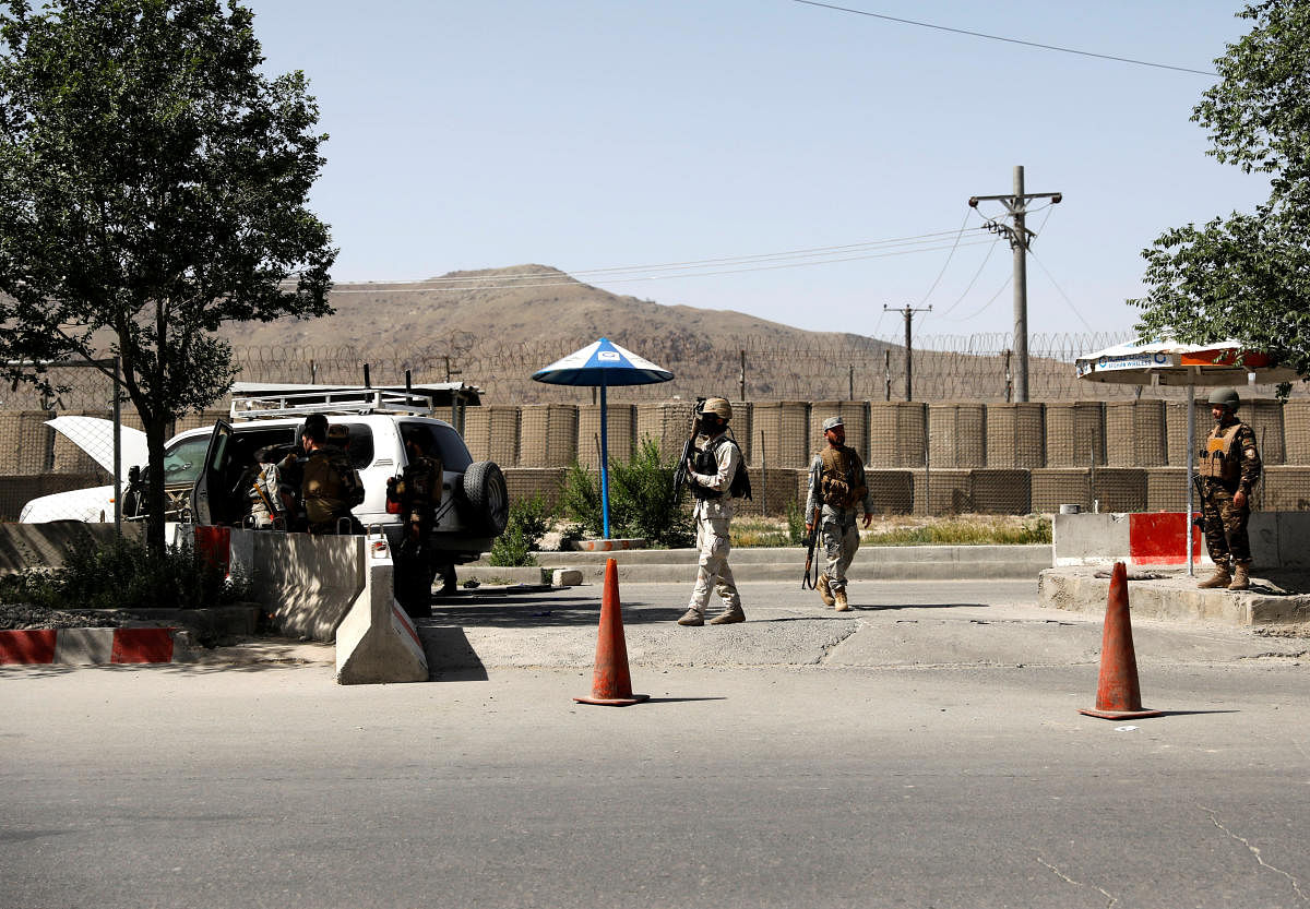 Afghan security forces inspect the at the gate of a Interior ministry after an attack in Kabul. Reuters photo.