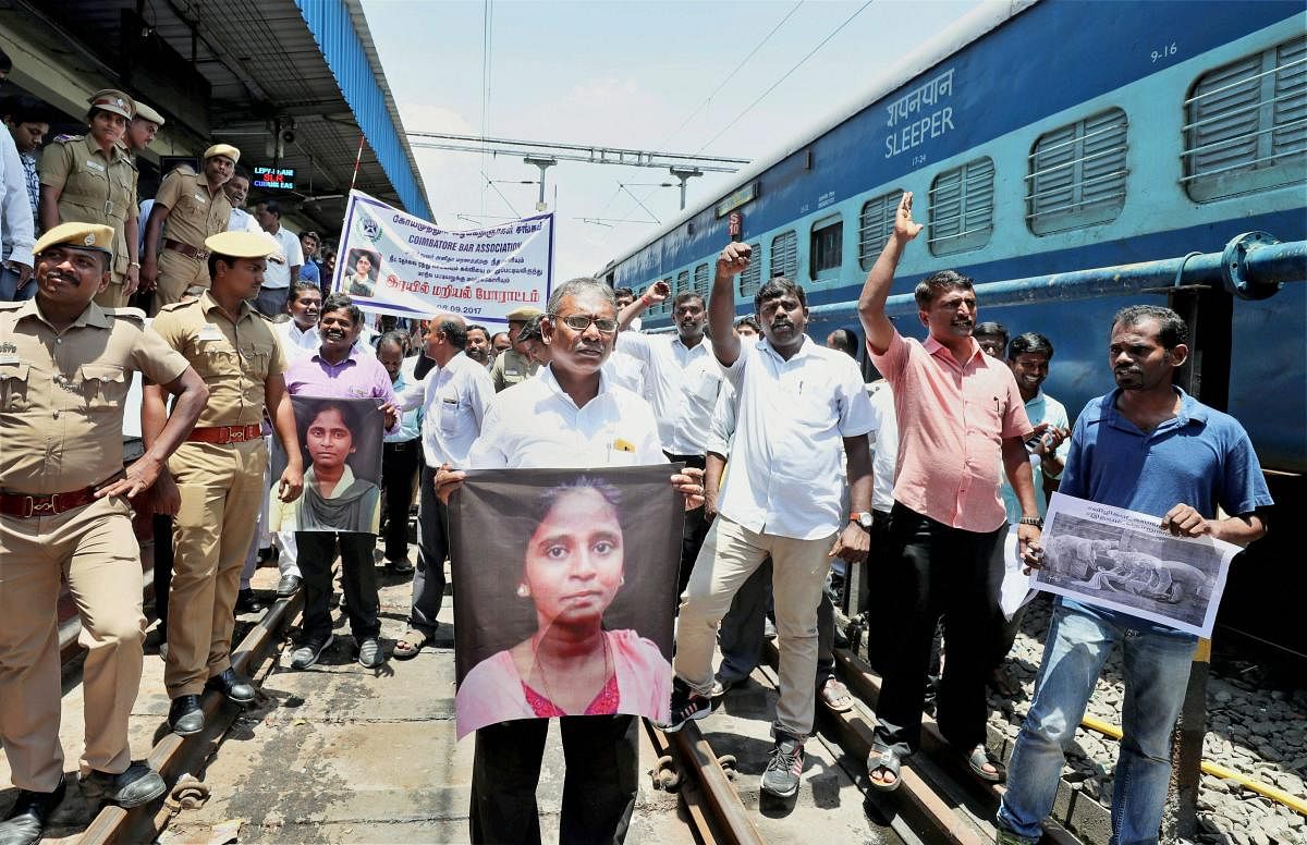 Members of the Coimbatore Bar Association raise slogans during a "rail roko" protest against NEET and demanding justice for the student S Anitha's death, in Coimbatore on Friday. PTI/FILE 