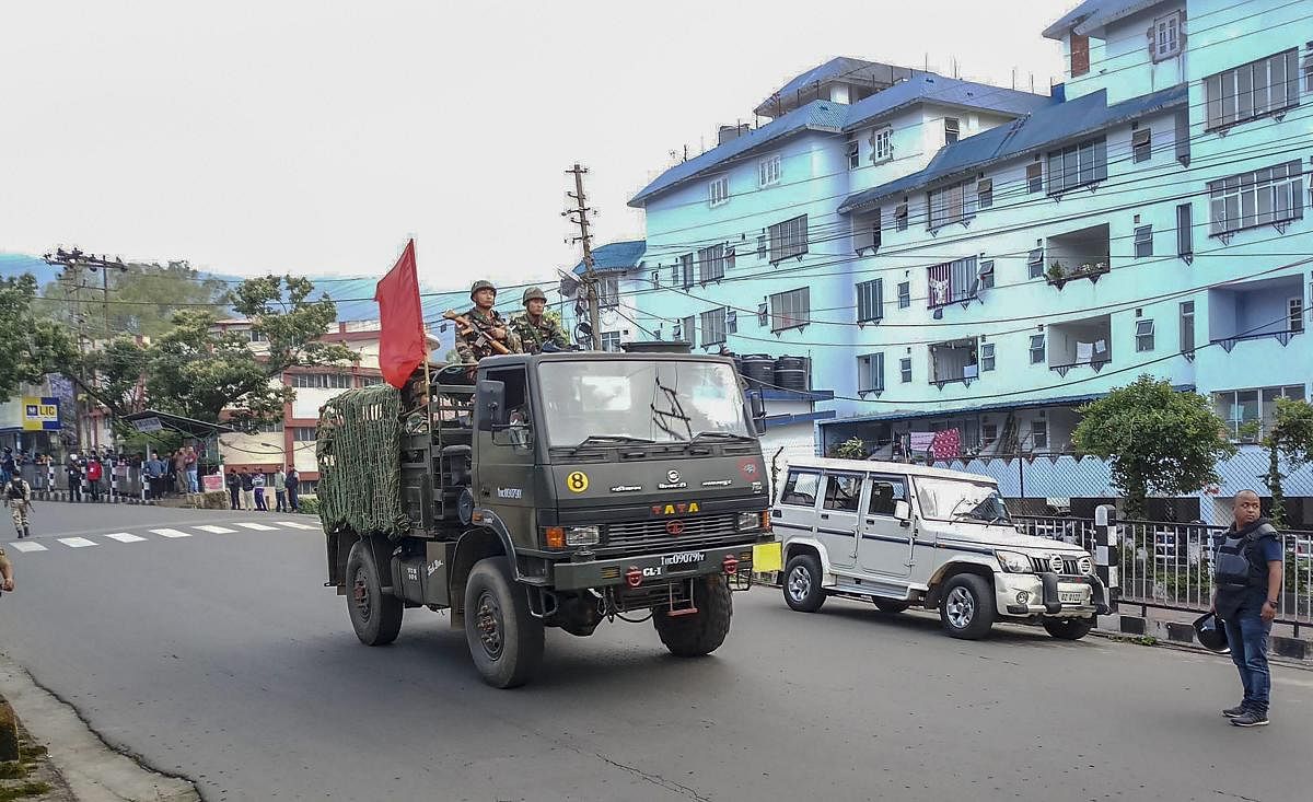 Army personnel patrol a street during curfew after clashes between the residents of the city's Punjabi Line area and Khasi drivers of state-run buses, in Shillong on June 4, 2018. PTI