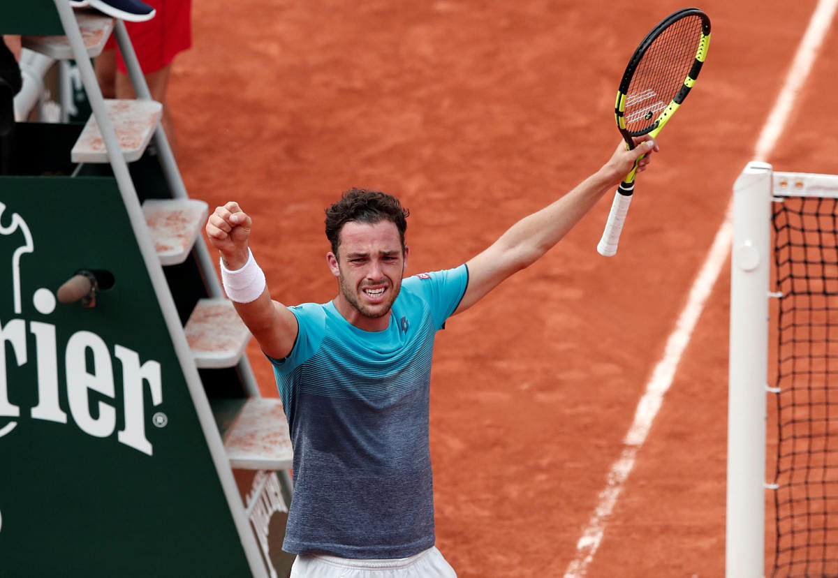 Italy's Marco Cecchinato celebrates winning his quarterfinal against Serbia's Novak Djokovic. REUTERS