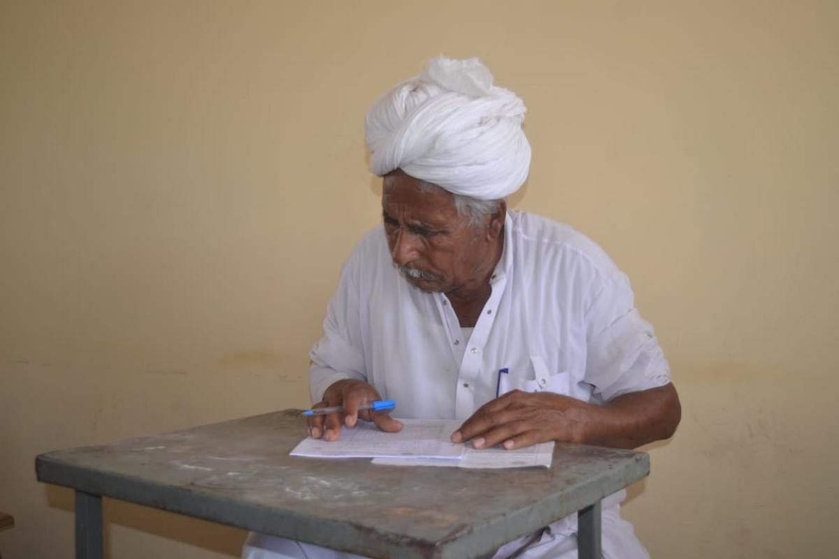 Andaram Jat, 82, appears for the class VIII examination at the Kota Open University in Barmer.