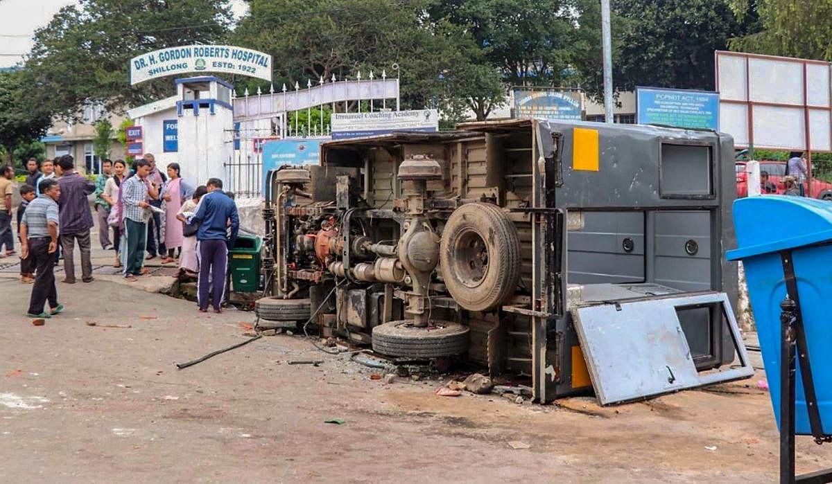 Shillong: A damaged UTI bus lies on a roadside after clashes between the residents of the city's Punjabi Line area and Khasi drivers of state-run buses, in Shillong on Monday, June 04, 2018. About 1,000 central paramilitary personnel have been sent to Meg
