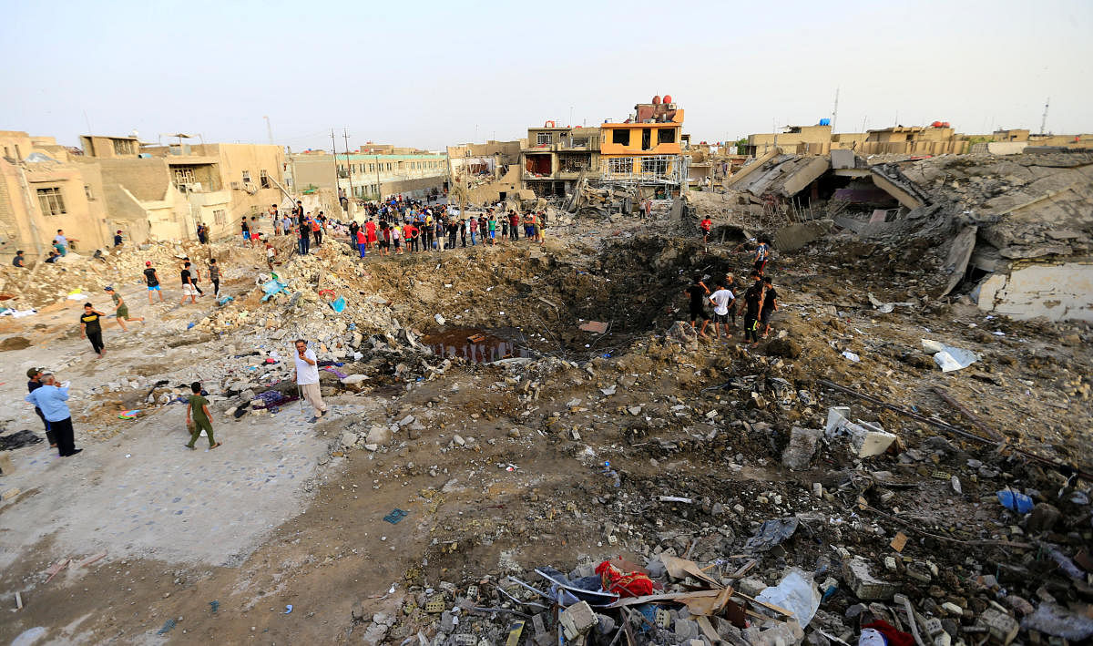 People gather at the site of an explosion in Baghdad's Sadr City district, Iraq June 7, 2018. (REUTERS/Thaier Al-Sudani)