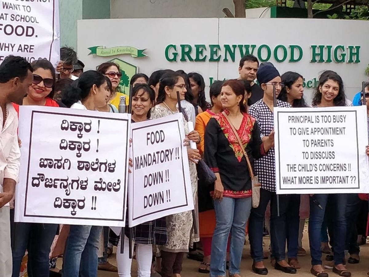Parents stage a protest in front of the Greenwood High School’s campus at Sarjapur on Saturday.