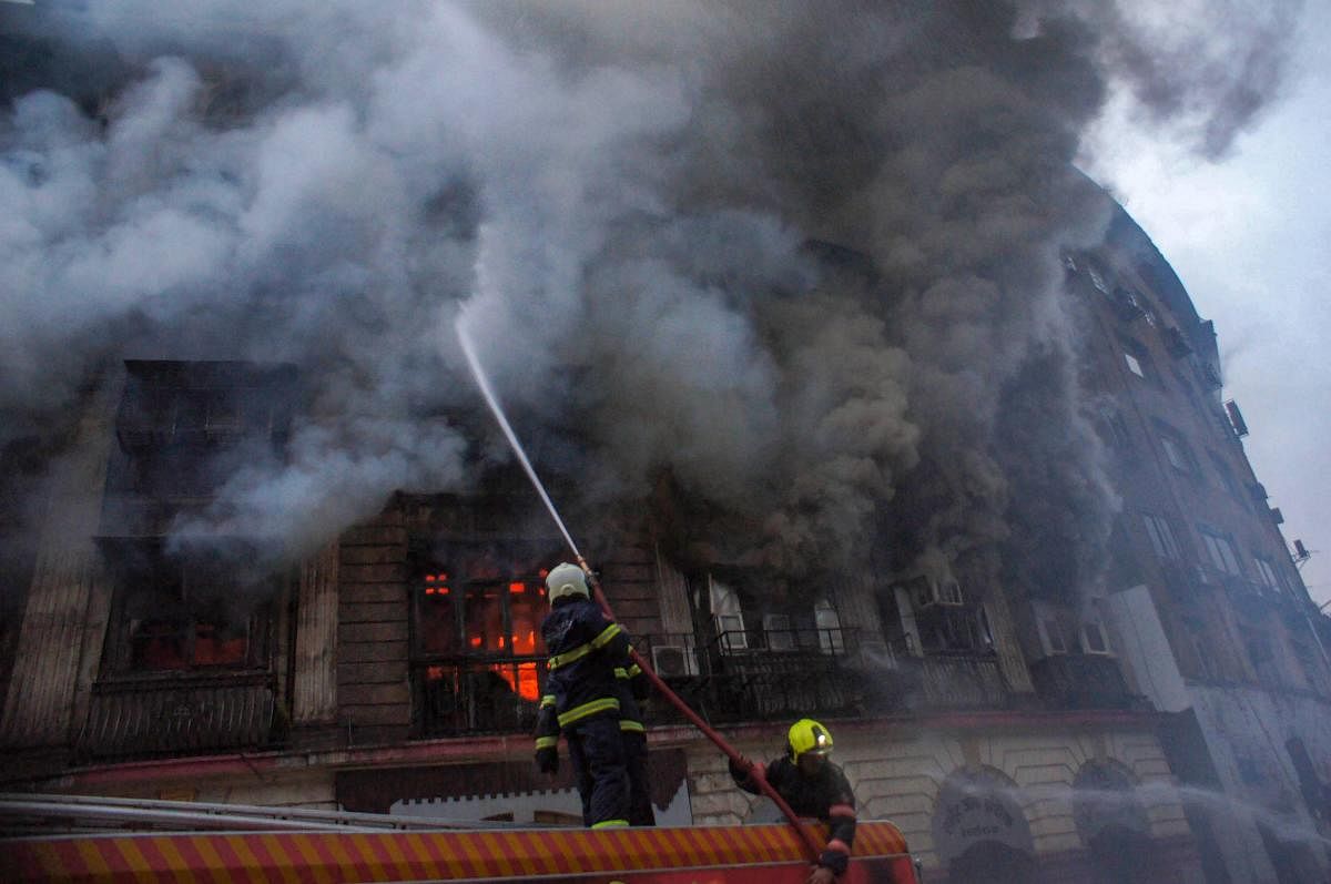 Firefighters douse a fire which broke out at Kothari mansion in south Mumbai on Saturday. PTI