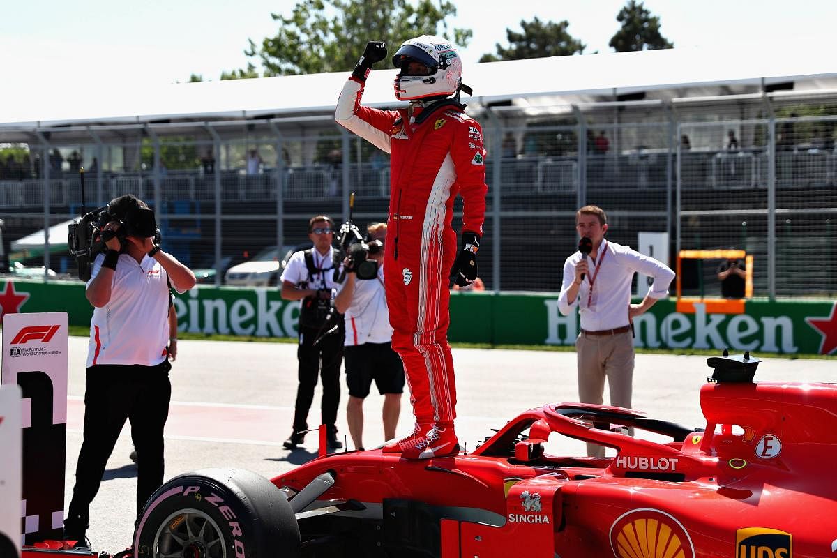 Ferrari's Sebastian Vettel celebrates after qualifying in pole for the Canadian Grand Prix. AFP