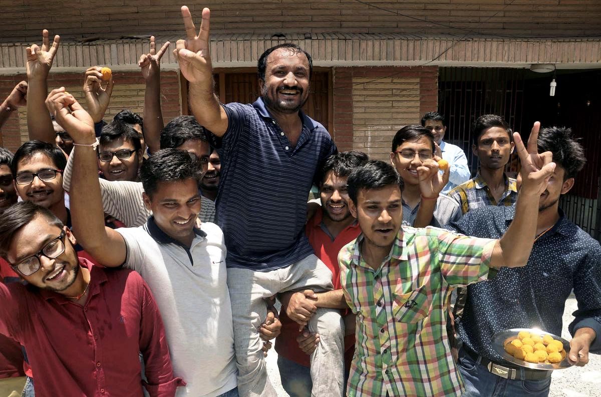 Super 30 founder Anand Kumar and his students celebrate the result of IIT-JEE that was declared today, in Patna. PTI photo
