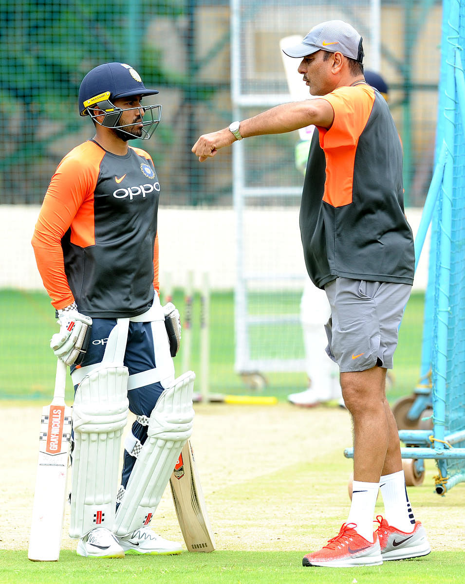 Karun Nair (left) gets some advice from coach Ravi Shastri during a training session on Monday. DH PHOTO/ SRIKANTA SHARMA R