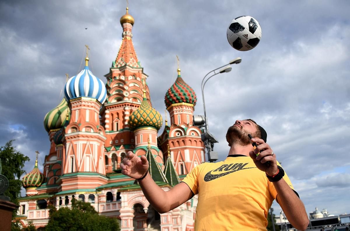 A man juggles with a ball in front of the St Basil's Cathedral on the Red Square in Moscow ahead of the World Cup. AFP