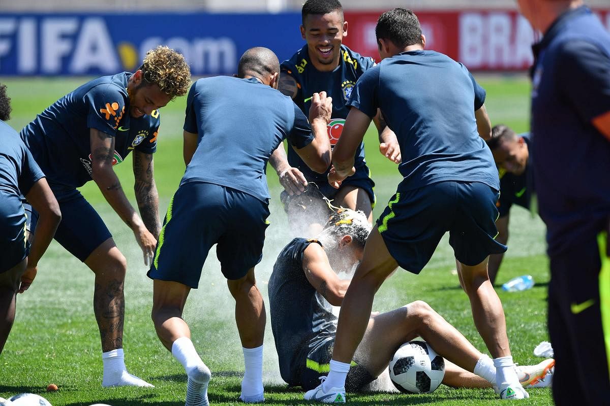Brazil's national team players break an egg on the head of teammate Philippe Coutinho (centre) as they celebrate his birthday, during a training session in Sochi on Tuesday. AFP