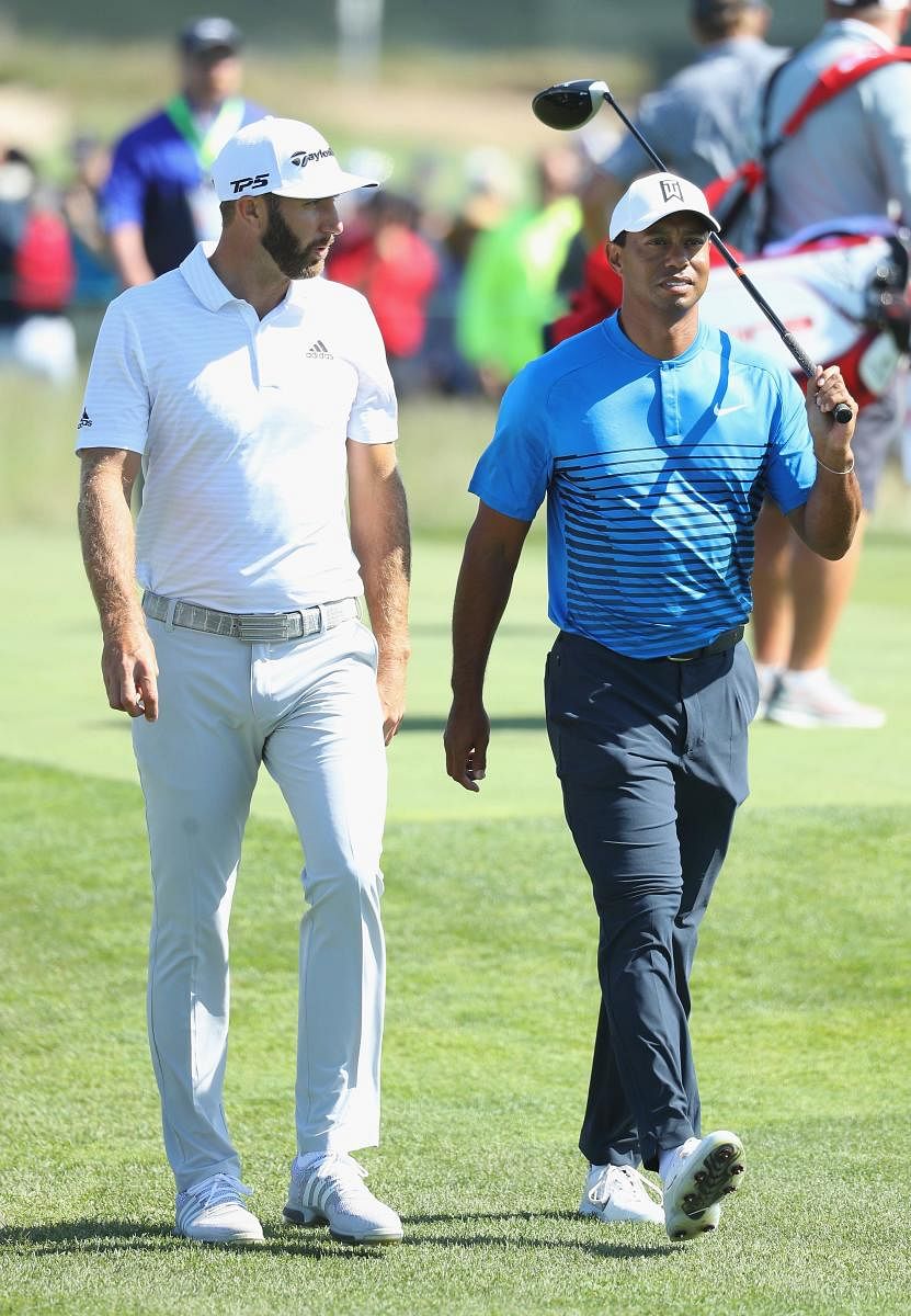 World No 1 Dustin Johnson (left) walks along with legend Tiger Woods during Wednesday's practice round ahead of the US Open. AFP