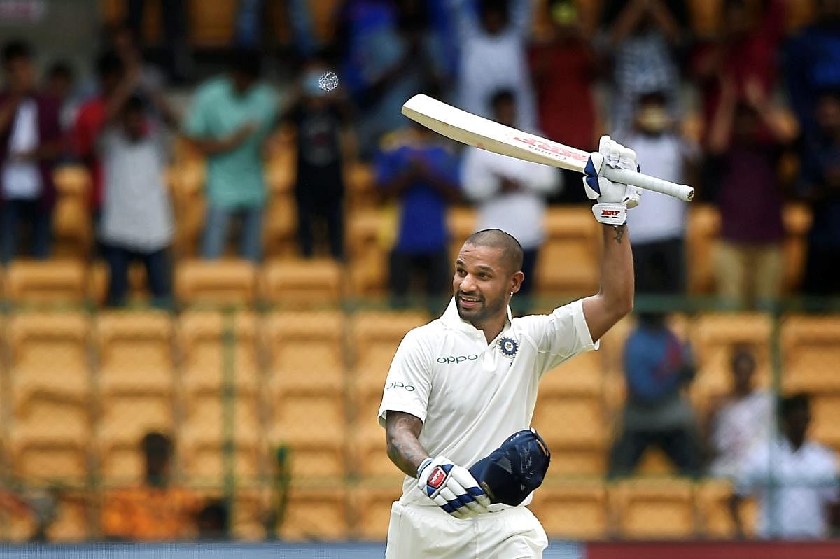 India's Shikhar Dhawan celebrates his century on the first day of the one-off cricket test match against Afghanistan, at Chinnaswamy Stadium in Bengaluru on Thursday, June 14, 2018. (PTI Photo/Shailendra Bhojak)