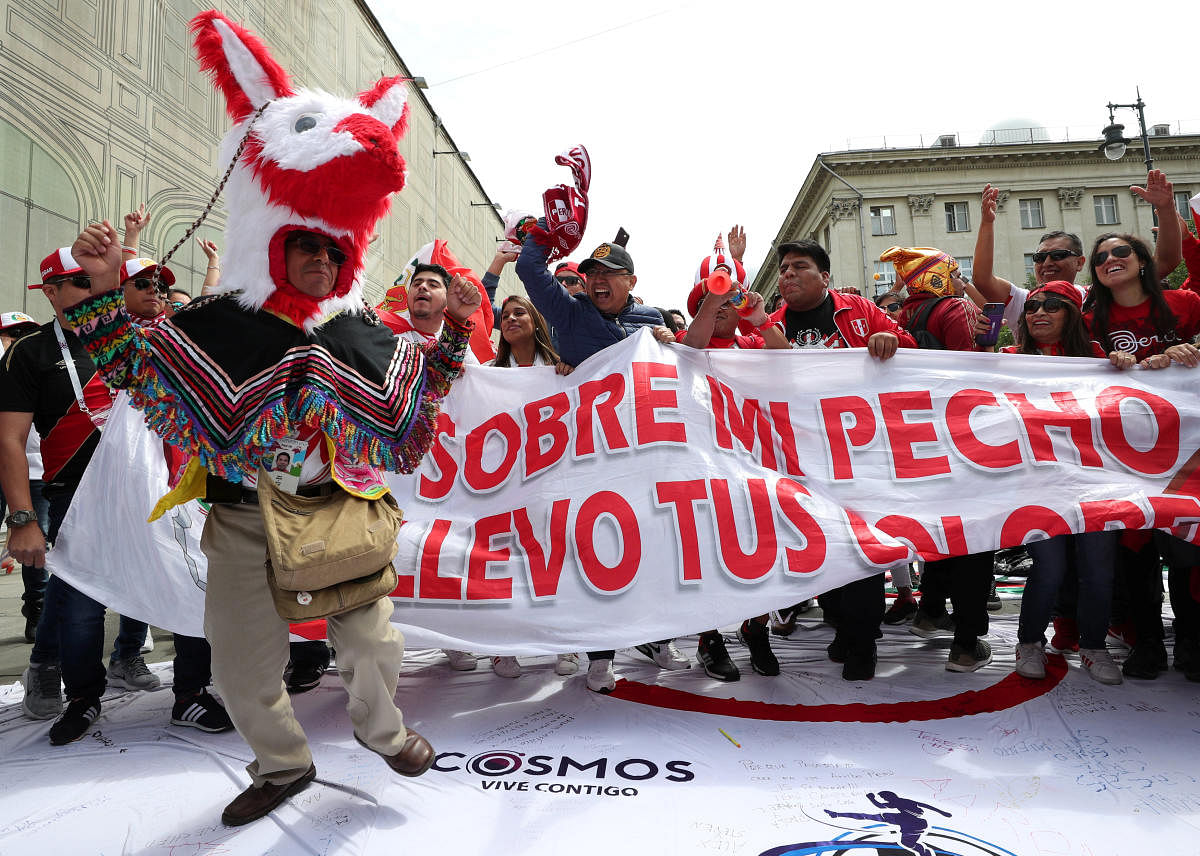 ALL FUN Fans of the Peruvian team parade on the streets. AFP