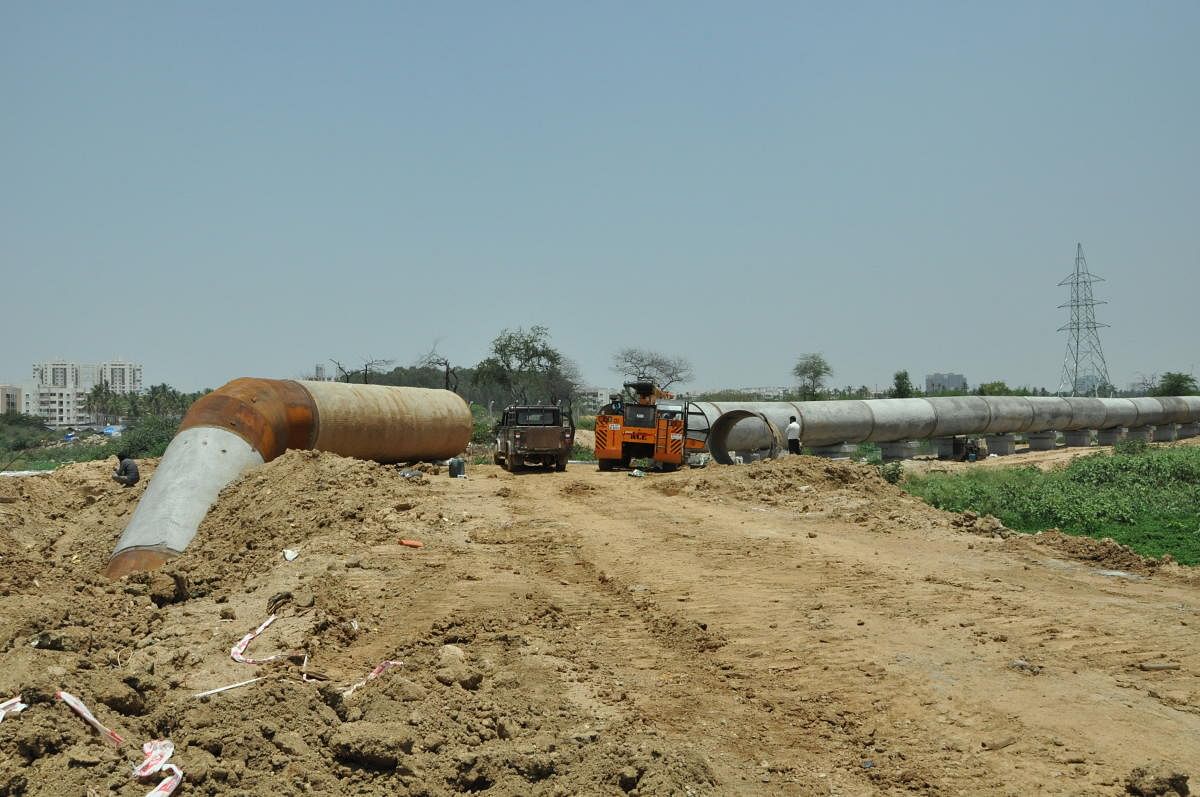 A mud road being laid through the Varthur Lake for laying a pipeline. DH FILE PHOTO