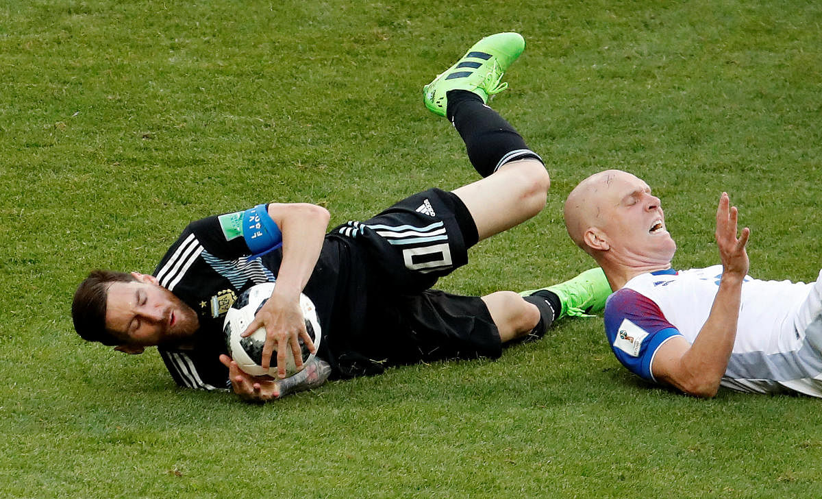 Argentina's Lionel Messi and Iceland's Emil Hallfredsson. REUTERS