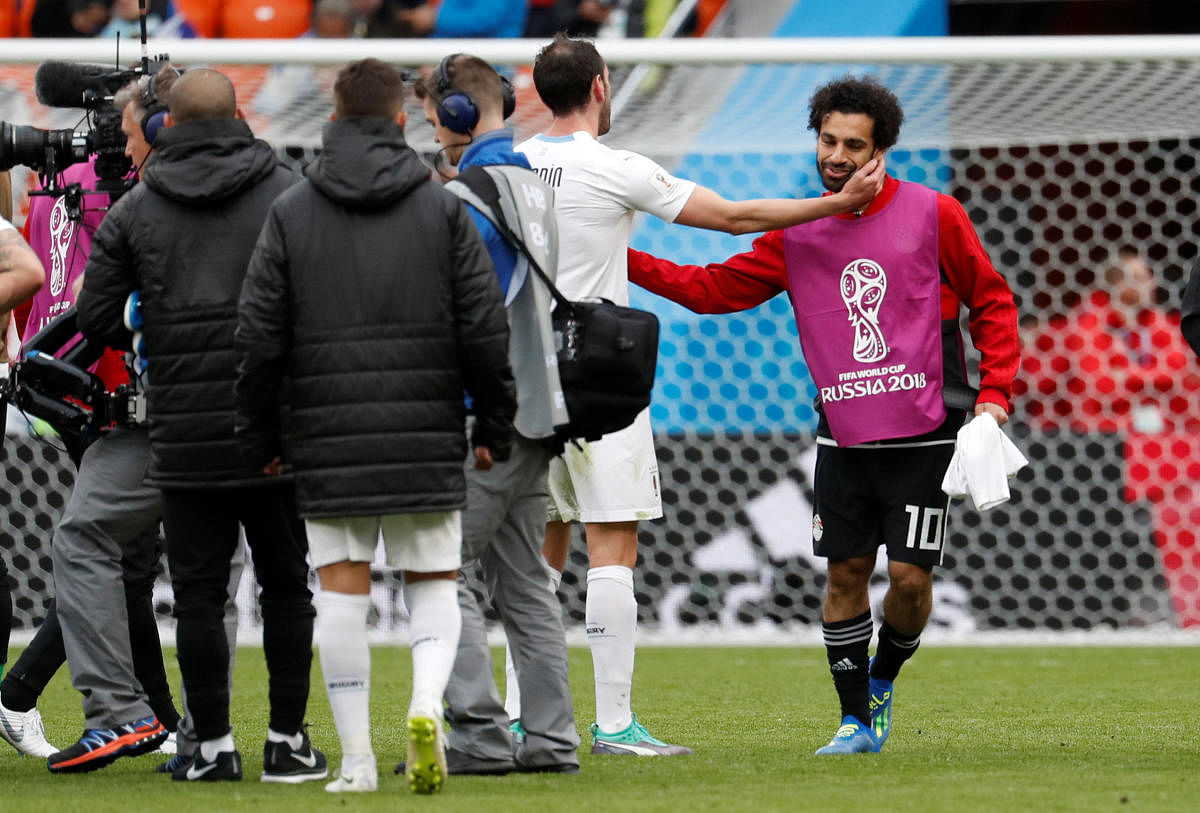 Egypt's Mohamed Salah with Uruguay's Diego Godin. REUTERS file photo.