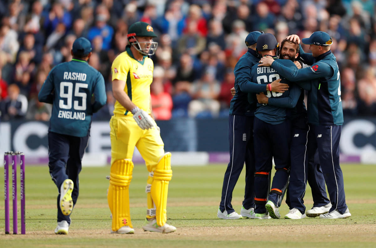 England's Moeen Ali celebrates taking the wicket of Australia's Glenn Maxwell with team mates. (Reuters Photo)