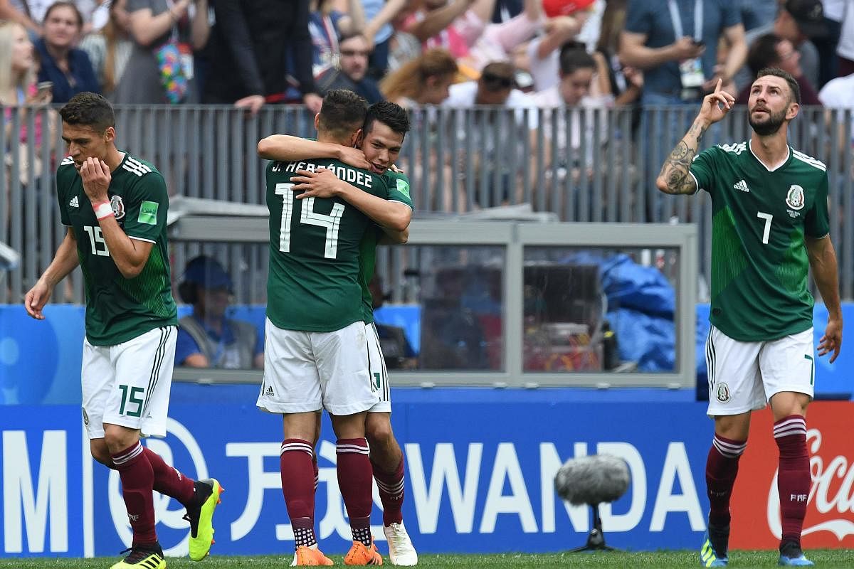 Mexico's forward Hirving Lozano celebrates the opening goal with teammates during the Russia 2018 World Cup Group F football match between Germany and Mexico at the Luzhniki Stadium in Moscow. AFP PHOTO
