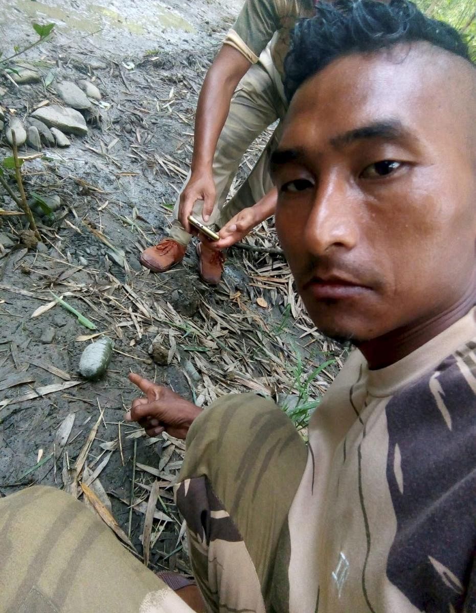 A security person shows an unexploded grenade at the site of an ambush by suspected NSCN-K on Assam Riffle personnel, at Aboi in Mon district of Nagaland on Sunday, June 17, 2018. At least four Assam Rifles personnel were killed in the ambush. (PTI Photo)